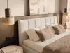 A bedroom scene with a bed, pillows, and bedside lamps. Produktbild-Vorschau