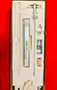 A knitting machine and its accessories are neatly arranged inside a cardboard box with styrofoam packaging. Produktbild-Vorschau