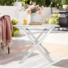 An outdoor patio scene with a white folding table set up. Anteprima dell’immagine prodotto