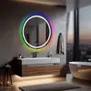 A modern bathroom with a round LED mirror, vanity, and bathtub, overlooking a city at dusk. Anteprima dell’immagine prodotto