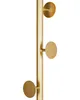 A close-up of a gold coat rack with three circular hooks. Náhled obrázku produktu