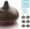 A dark brown wood-grain patterned ultrasonic air humidifier with a glowing pink light ring around its base. Text and smaller product images are to the right. Anteprima dell’immagine prodotto