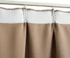 A close-up view of the top portion of taupe curtains hanging from a white curtain rod. Anteprima dell’immagine prodotto