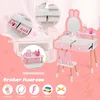 A pink and white children's vanity set with a mirror, drawers, and a stool, surrounded by illustrative graphics and text highlighting features. Podgląd zdjęcia produktu