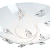 A close-up view of a ceiling light fixture with crystal-like embellishments. Produktbild-Vorschau