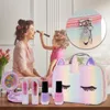 A mother and daughter are playing with makeup, with a unicorn-themed makeup bag and cosmetics in the foreground. Voir les images du produit