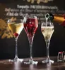 Three champagne glasses filled with different colored beverages, with a bottle of champagne pouring into one of them. Anteprima dell’immagine prodotto