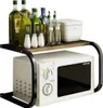 A microwave oven with a shelf organizer on top, filled with bottles and containers. Náhľad obrázku produktu