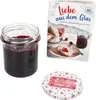 A jar of jam, a cookbook, and a jar lid are displayed against a white background. Produktbild-Vorschau