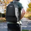 A person wearing a backpack walks on a path outdoors. Produktbild-Vorschau