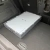 A gray folding storage box with a white lid is placed in the trunk of a car. Produktbild-Vorschau
