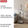 A shelf unit with decorative items and books next to a sofa and a floor lamp. Produktbild-Vorschau