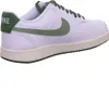A side view of a white Nike sneaker with green accents. Produktbild-Vorschau