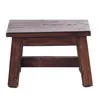 A small, dark brown wooden stool is shown against a white background. Produktbild-Vorschau