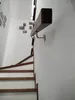 A wooden handrail is mounted on a white wall next to a wooden staircase. Náhľad obrázku produktu