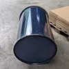 A dark blue metal barrel lies on a concrete floor next to a stack of cardboard boxes on a pallet. Anteprima dell’immagine prodotto