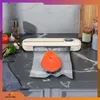 A vacuum sealer is shown sealing a piece of salmon in a plastic bag on a kitchen counter. Podgląd zdjęcia produktu