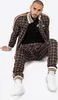A man is sitting down wearing a tracksuit. Anteprima dell’immagine prodotto