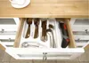 An open kitchen drawer with a cutlery organizer holding various utensils and an electric universal shear. Produktbild-Vorschau