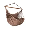 A hanging chair suspended from a wooden spreader bar and a metal hook. Produktbild-Vorschau