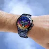 A close-up shot of a man's wrist wearing a colorful Festina chronograph watch against a blurred blue and gray background. Voir les images du produit