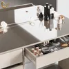 A close-up view of a vanity table with makeup and accessories organized in an open drawer, with a mirror reflecting some items. Voir les images du produit