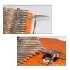 Close-up shots of a kalimba instrument, showing the metal tines and wooden body, with a tuning hammer. Produktbild-Vorschau