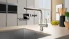 A modern kitchen sink area with a faucet, countertop, and some decorative items. Produktbild-Vorschau