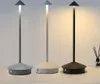 Three modern LED table lamps in different colors displayed on a surface. Produktbild-Vorschau