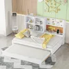 A white trundle bed with a built-in shelf unit and corkboard, set up in a child's room with decorative elements on the wall. Produktbild-Vorschau