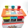 A toy car garage with three parking spots and colorful doors. Voir les images du produit