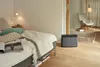 A bedroom with a bed and an air purifier. Náhled obrázku produktu