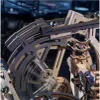 A close-up view of a complex wooden mechanical model, likely a marble run or a kinetic sculpture, with several metallic spheres visible. Podgląd zdjęcia produktu