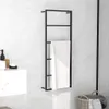 A black towel rack with a white towel hanging on it, placed on a marble-patterned wall next to a sink. Náhled obrázku produktu