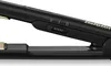 Close-up of a black hair straightener with gold accents, showing the control dial and branding. Voir les images du produit