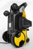 A yellow and black pressure washer is shown from a low angle, resting on its wheels against a white background. Produktbild-Vorschau