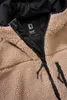A close-up view of the inside of a beige teddy fleece jacket, showing the zipper and a brand label. Produktbild-Vorschau