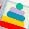 A close-up view of a soft toy book with colorful felt shapes arranged in a pyramid. Produktbild-Vorschau