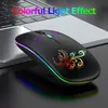 A black wireless mouse with colorful lighting effects and a phoenix design is placed on a laptop. Produktbild-Vorschau
