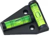 A black triangular base with two green bubble levels attached. Produktbild-Vorschau