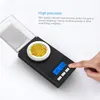 A hand is pressing a button on a small digital scale with a pile of gold-colored beads on it. Podgląd zdjęcia produktu