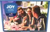 People enjoying a meal together, with a product box visible. Produktbild-Vorschau