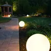 A garden path leading to a gazebo, illuminated by spherical garden lights at dusk. Produktbild-Vorschau