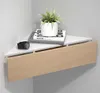 A corner shelf with a drawer, decorated with a plant and books. Voir les images du produit