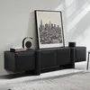 A modern black wooden TV cabinet with a framed cityscape artwork above it, placed against a white wall. Produktbild-Vorschau