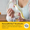 A person is holding a breast pump with a bottle attached. Podgląd zdjęcia produktu