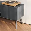 Close-up of a dark gray TV stand with a turntable on top, showing its legs and a cabinet door. Anteprima dell’immagine prodotto