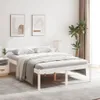 A white wooden bed frame with bedding in a bedroom setting. Produktbild-Vorschau