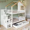 A children's bunk bed with a house-like design, featuring stairs, storage drawers, and stuffed animals. Náhled obrázku produktu