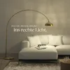 A modern living room with a white sectional sofa and a gold arc floor lamp. Náhled obrázku produktu